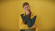 © Krakenimages.com - Handsome redhead bearded man in retro outfit contemplating against a yellow background