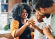 © Lumos sp - child family kitchen boy son mother father drink breakfast milk healthy drinking food eating glass home black african american father man together love cute childhood