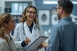 © Yuliia - Beautiful young female doctor, wearing eyeglasses, smiling and laughing, holding clipboard and talking with businessman, both looking at computer screen in medical office.