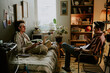 © AnnaStills - Best friends chilling and having heated conversation during remote work day in dormitory