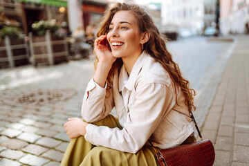 Canvas Print - Outdoor portrait happy female tourist having good time wandering around town in summer. Fashion style. Tourist attraction.