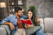 © Miljan Živković - relax couple boyfriend and girlfriend sit on sofa and read a book