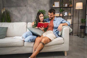 Wall Mural - relax couple boyfriend and girlfriend sit on sofa and read a book