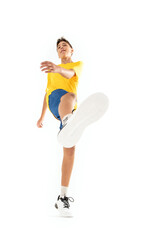 Photo of happy teen boy in sportswear posing on white studio background.