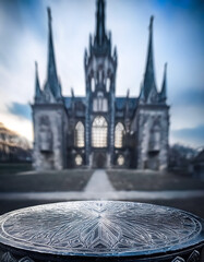 Sticker - Ornate Table in Front of a Blurred Gothic Cathedral