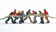 © Steven - Group of diverse miniatures engaging in a tug of war on a white background, symbolizing teamwork and competition.