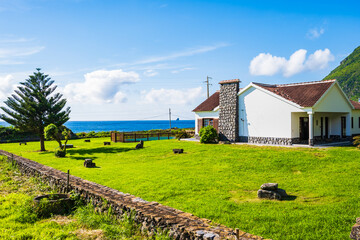 House with beautiful garden on ocean coast in Faja Grande village, Flores island, Azores, Portugal