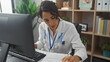© Krakenimages.com - A focused hispanic woman doctor reviewing documents in a hospital office setting