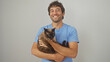 © Krakenimages.com - Smiling young adult hispanic man holding a siamese cat against an isolated white background