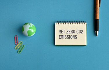 There is notebook with the word Net zero CO2 emissions. It is as an eye-catching image.