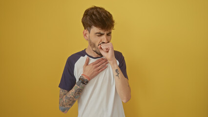 Poster - A young tattooed man coughing against a vibrant yellow wall, depicting health or discomfort.