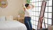 © Krakenimages.com - Young beautiful hispanic woman smiling confident dancing looking at the mirror at bedroom