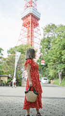 Wall Mural - Beautiful hispanic woman in glasses, confidently posing and smiling, enjoying her casual successful travel around tokyo's vibrant streets.