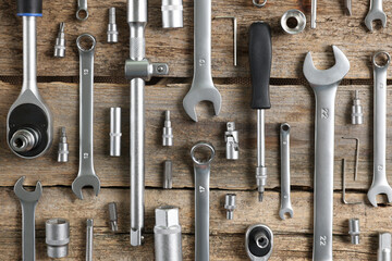 Poster - Different auto mechanic's tools on wooden table, flat lay