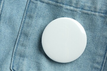 Sticker - White button badge pinned on denim shirt, top view. Mockup for design