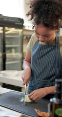 Canvas Print - Culinary, woman and knife with onion for cut, chop and food preparation technique for fine dining on table. Kitchen, cooking and female chef with raw vegetable, hospitality or helping hand for skills