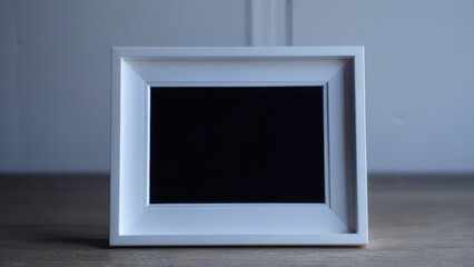  an empty picture frame with two fingers on the top of it,