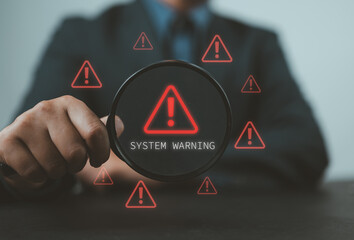 Fototapete - System Warning Alert, Cyber Security Concept. Hand holds magnifying glass over digital warning sign with red exclamation marks, system warning or potential malicious cyber attack alert. Cybersecurity,
