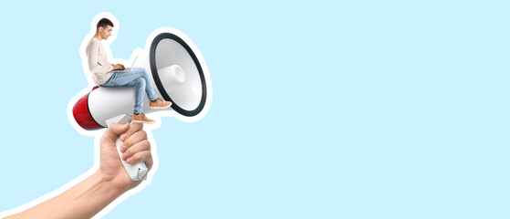 Female hand with megaphone on blue background