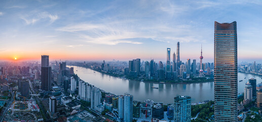 Aerial view of modern city skyline and buildings at sunrise in Shanghai.