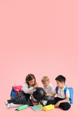 Wall Mural - Little school children with globe on pink background