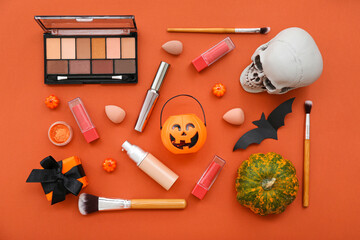 Wall Mural - Composition with makeup products and Halloween decor on orange background