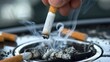 © Boomanoid - Hand putting out cigarette in car ashtray