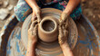 © Valeriia - Process of making clay pot on pottery wheel, potter hands two people creating ceramic handcrafts, ceramist molding jar or vase cup mug. Pottery lesson master class for adult creative hobby concept