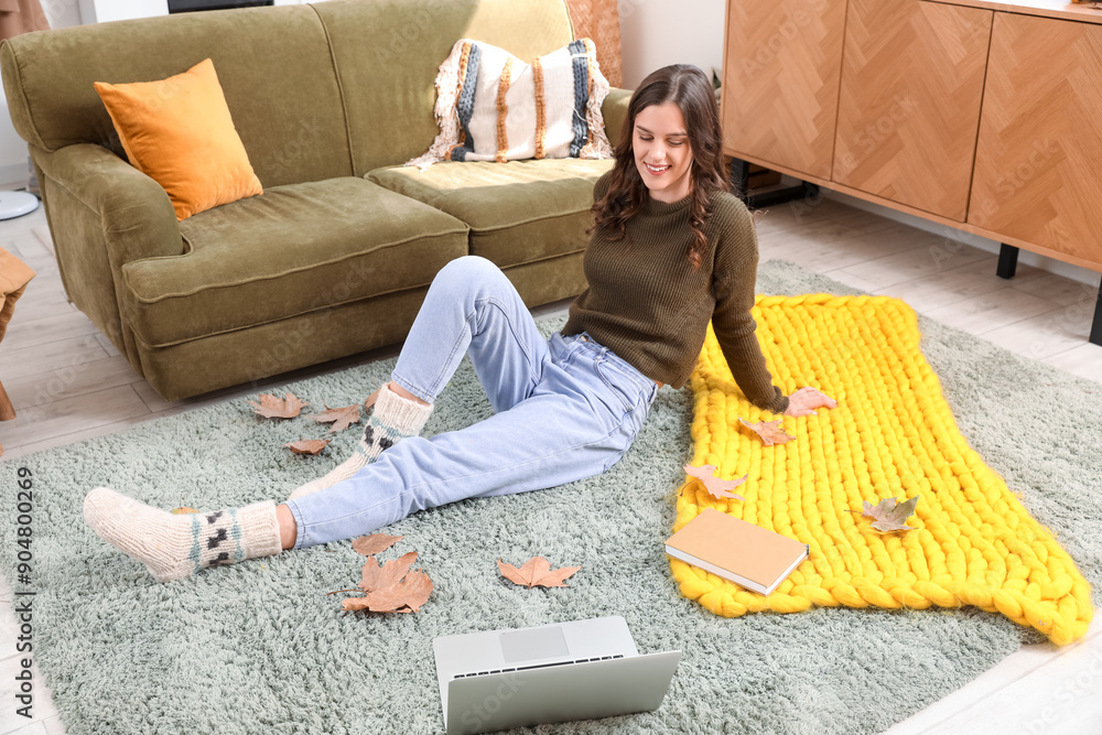 Young woman sitting at home on autumn day