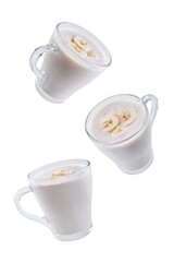 Wall Mural - Banana milkshake with banana slices in a glass on a white isolated background