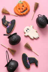 Wall Mural - Halloween composition with brooms, cauldrons and witch hats on pink background