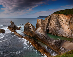 Wall Mural - Fascinating natural rock formations showcase a palette of earthy tones on the seashore