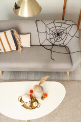 Wall Mural - Interior of light living room decorated for Halloween with sofa and table