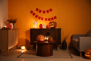 Poster - Interior of dark living room with Halloween pumpkins and burning candles