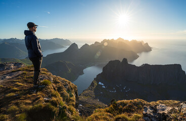 Fototapete - A man wachting the midnightsun on summit Grytetippen on Senja, Norway.