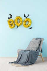 Wall Mural - Word BOO made of balloons with paper bats and armchair in living room