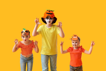 Canvas Print - Little children dressed for Halloween on yellow background