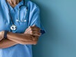 © tantawat - Compassionate Nurse Comforting Patient with Gentle Smile and Caring Hands in Soft Blue Isolated Background for Healthcare Concept. Copy Space Available.