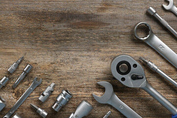 Canvas Print - Different auto mechanic's tools on wooden table, flat lay. Space for text