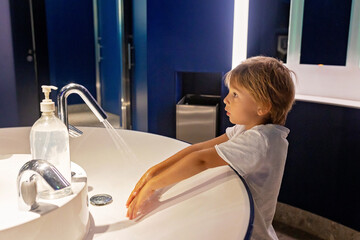 Canvas Print - Little boy, kid washing hands in a public bathroom in Monaco, Monte Carlo