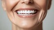 © saichon - Hyper-realistic close-up of a senior's mouth with a confident, healthy smile, featuring dentures and pristine teeth, ideal for online dental care promotion
