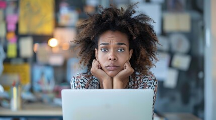 Poster - A young woman sits at her desk, looking at her laptop with a thoughtful expression. AI.