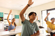 © wavebreak3 - In high school, students raising hands to answer question in classroom
