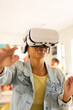 © wavebreak3 - Using VR headset, teenager exploring virtual reality in high school classroom