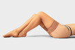 © Pixel-Shot - Legs of beautiful woman wearing stockings on light background