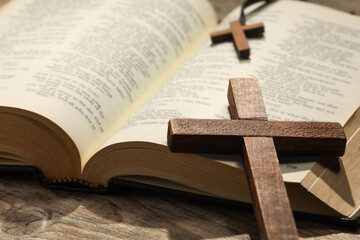 Wall Mural - Bible and crosses on wooden table, closeup. Religion of Christianity