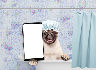 Wall Mural - Funny Mastiff puppy wearing shower cap takes the bath shows big smartphone with white blank screen in it paw. Empty space for text