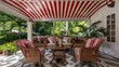 © Alexander Kurilchik - Tropical Patio with Red and White Striped Awning and Wicker Furniture Surrounded by Palm Trees