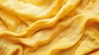 © AkuAku - Wrinkled pure yellow linen fabric background evokes cozy home ambiance