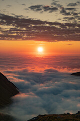 Sea of clouds at dramatic colorful evening sky during the midnight sun in the Lofoten, Northern Norway